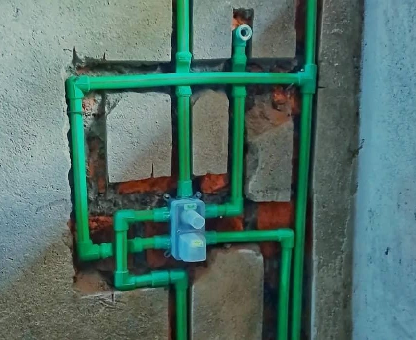 Concealed green water-line pipework installed into a masonry wall