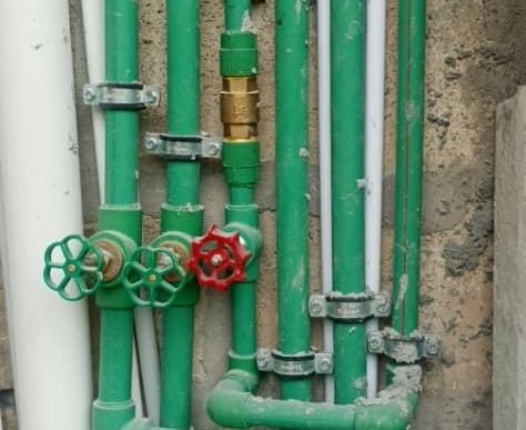 Vertical plumbing distribution pipework with control valves installed by FlowTech